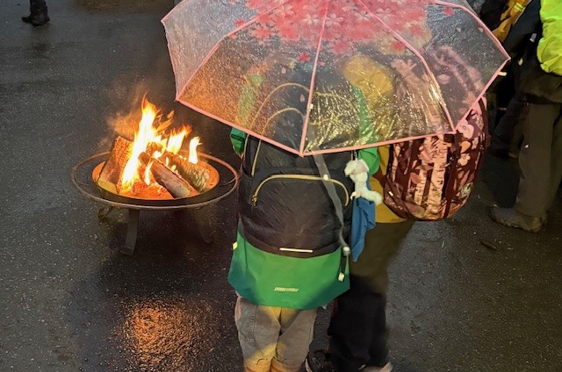 en person som holder en paraply over et bål