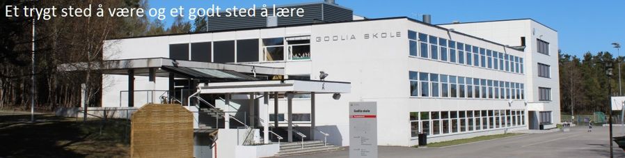 Bilde av skolen med skolemottoet